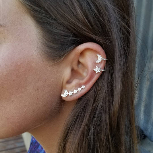 Conjunto de pendientes y brazaletes con forma de luna y estrella